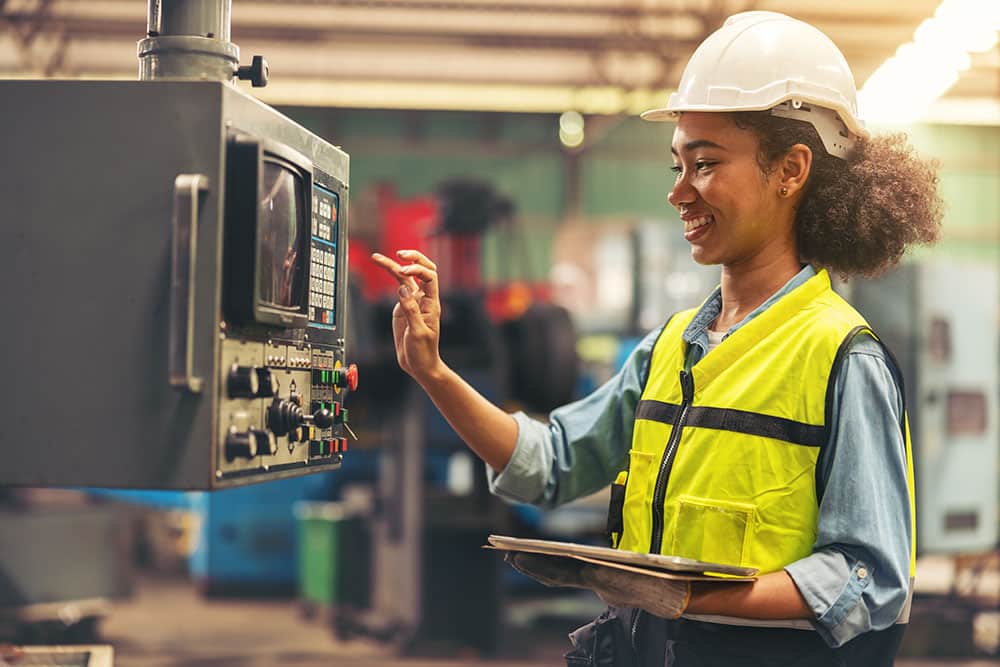 female standing in front of a control panel